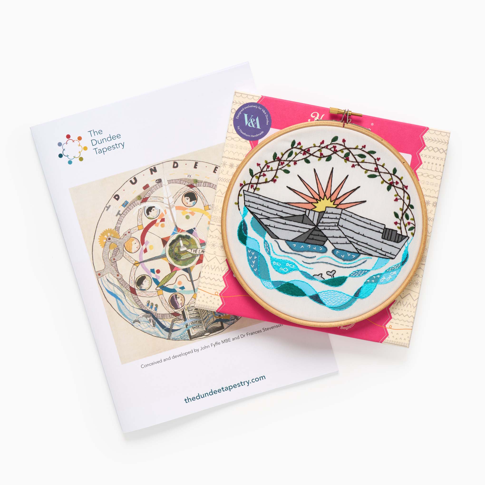 A book titled 'The Dundee Tapestry' with an embroidery kit on top of it,