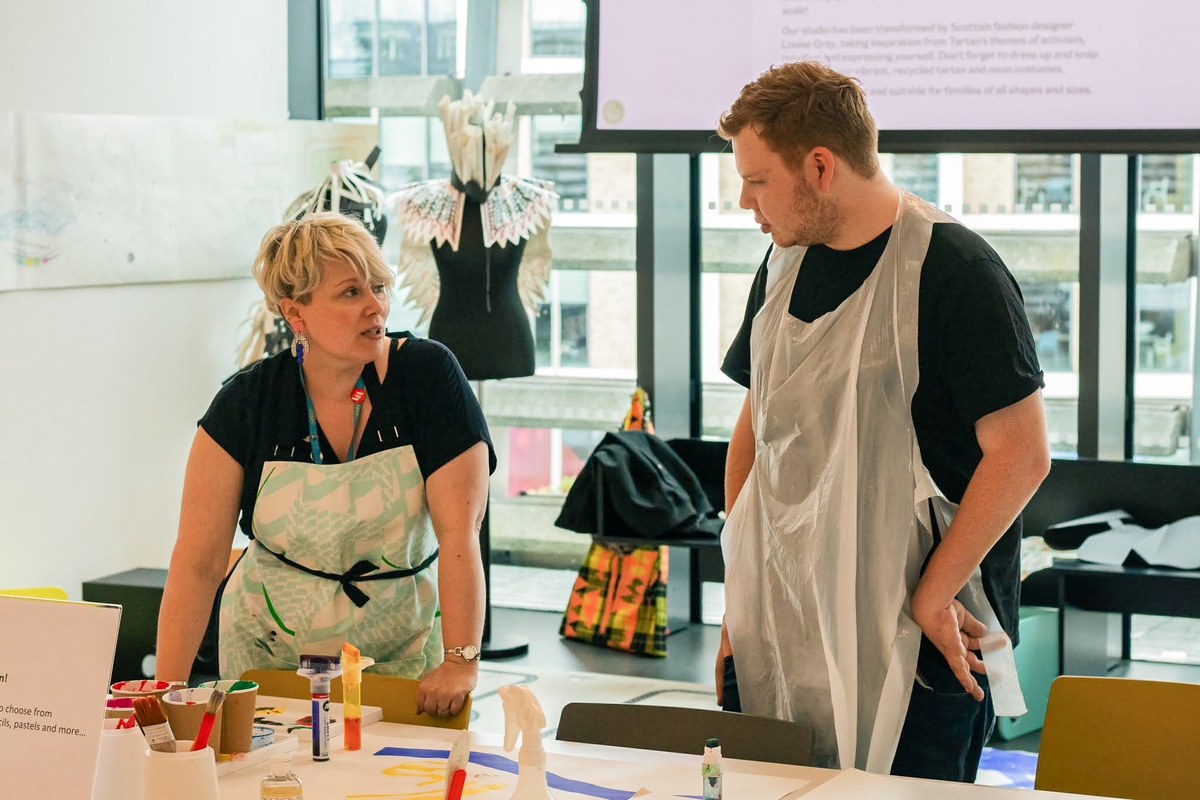 Two adults engaging in a workshop at V&A Dundee