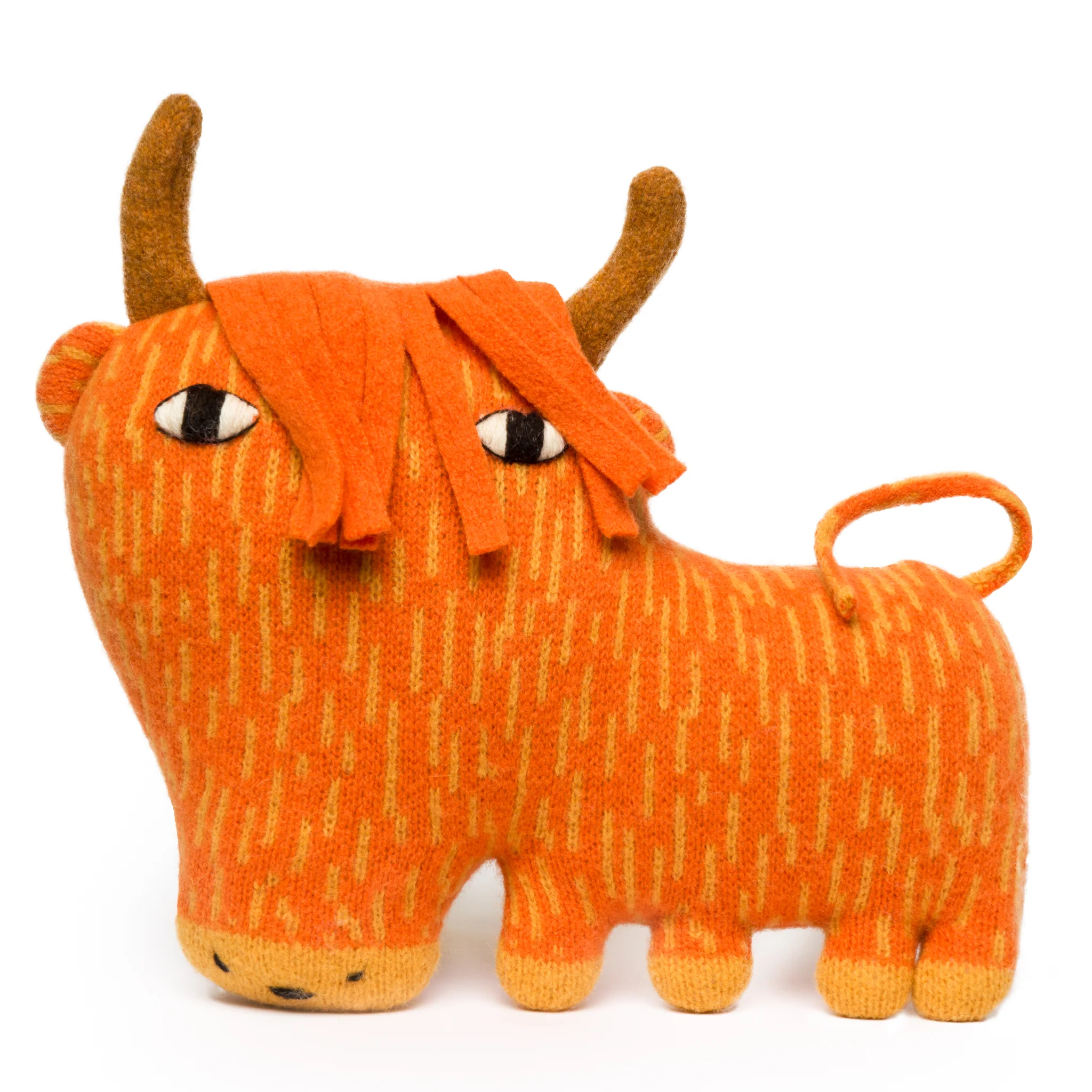 An orange cuddly cow toy