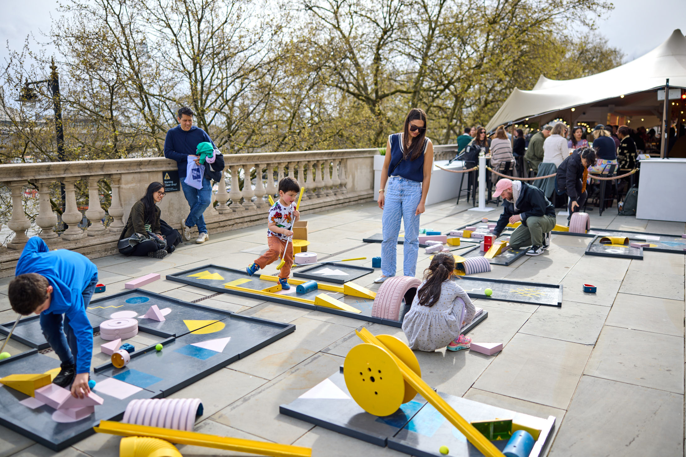 A family playing a game of interactive crazy golf