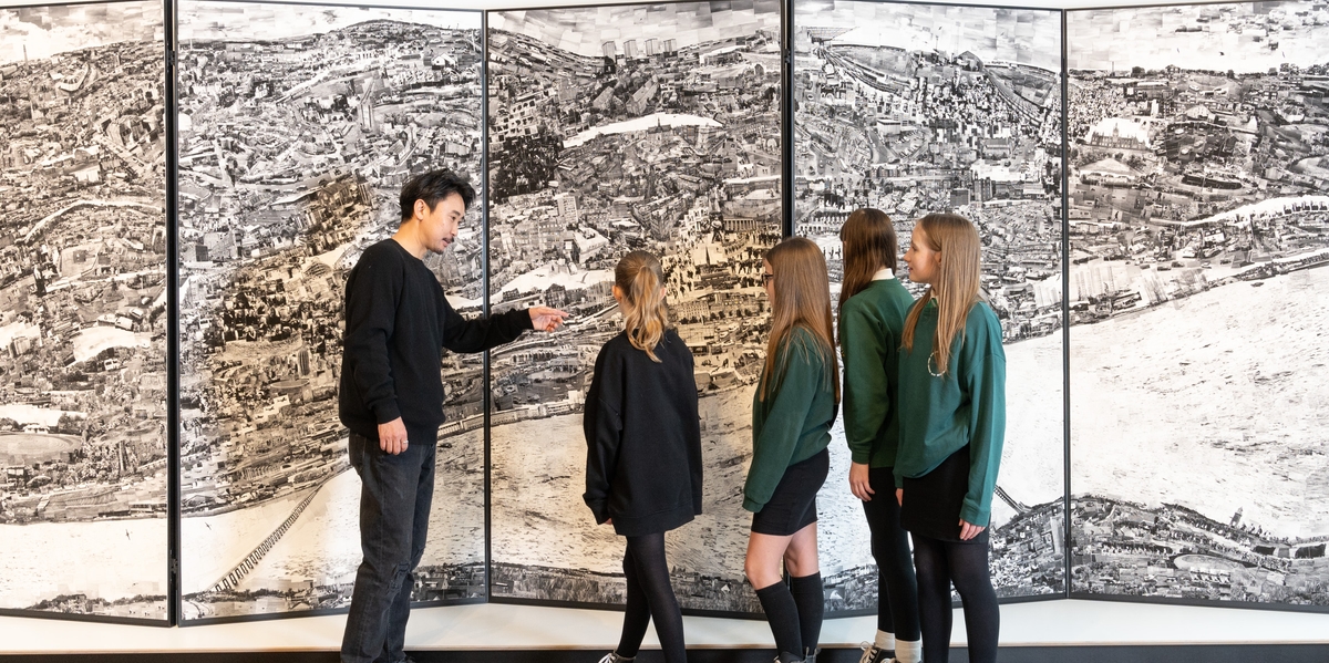 A group of people looking at the Dundee diorama map