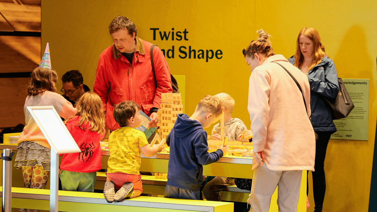 Children and their parents playing with KAPLA blocks in the foyer of V&A Dundee