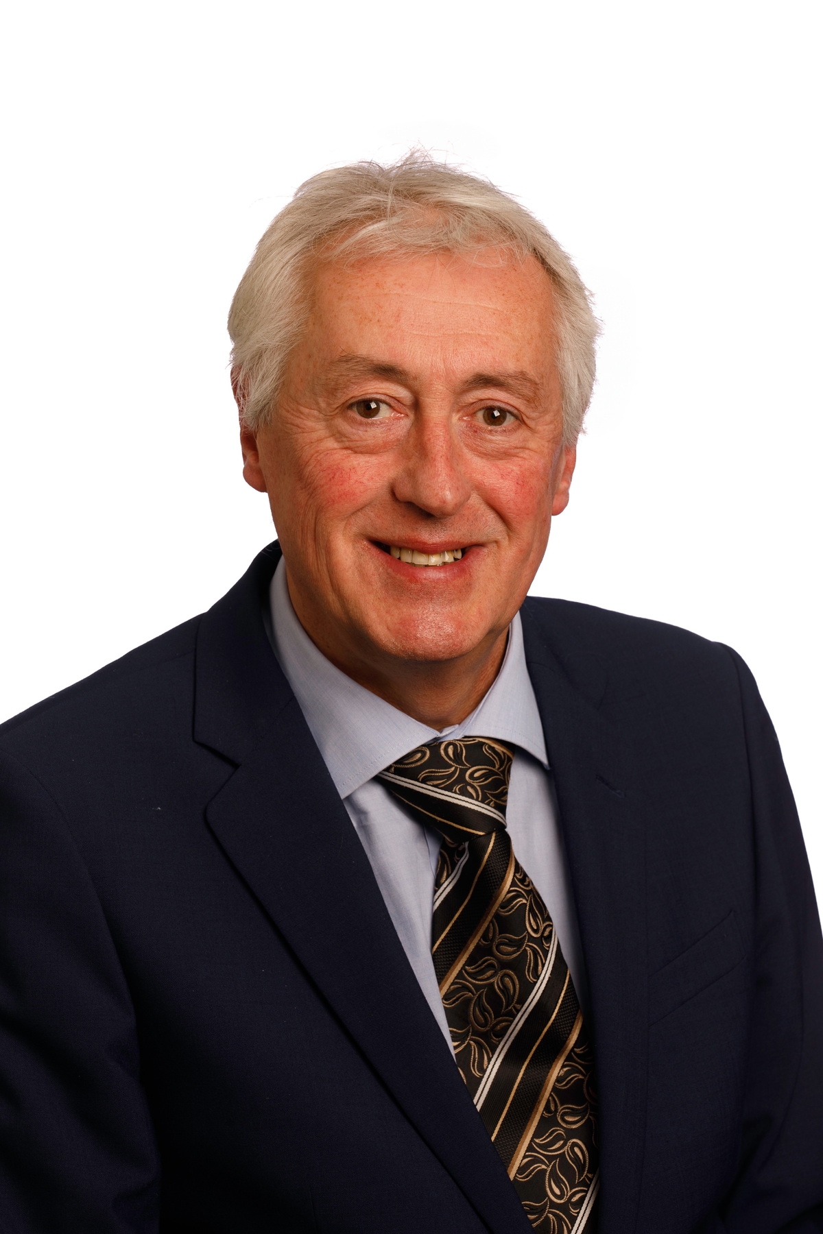 A portrait of a man in a suit looking at the camera.