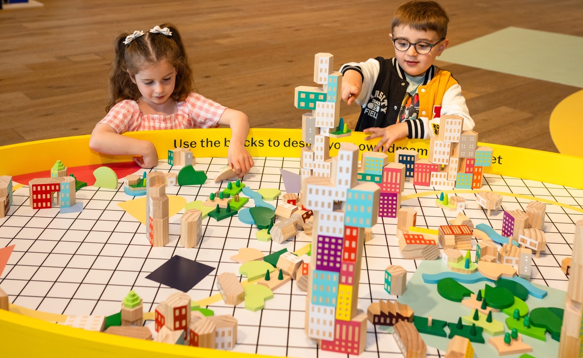 Two children building a cities with building blocks