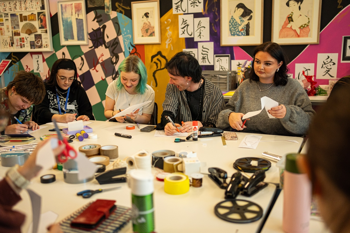 A group of young people making crafts.