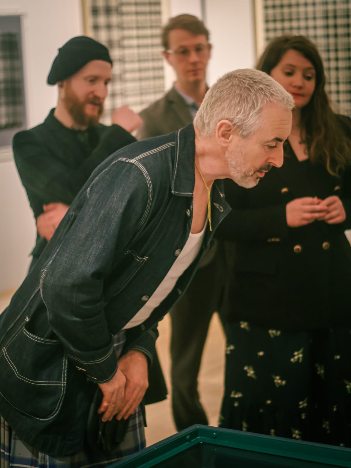 Alan Cumming looking at an case in the Tartan exhibition at V&A Dundee