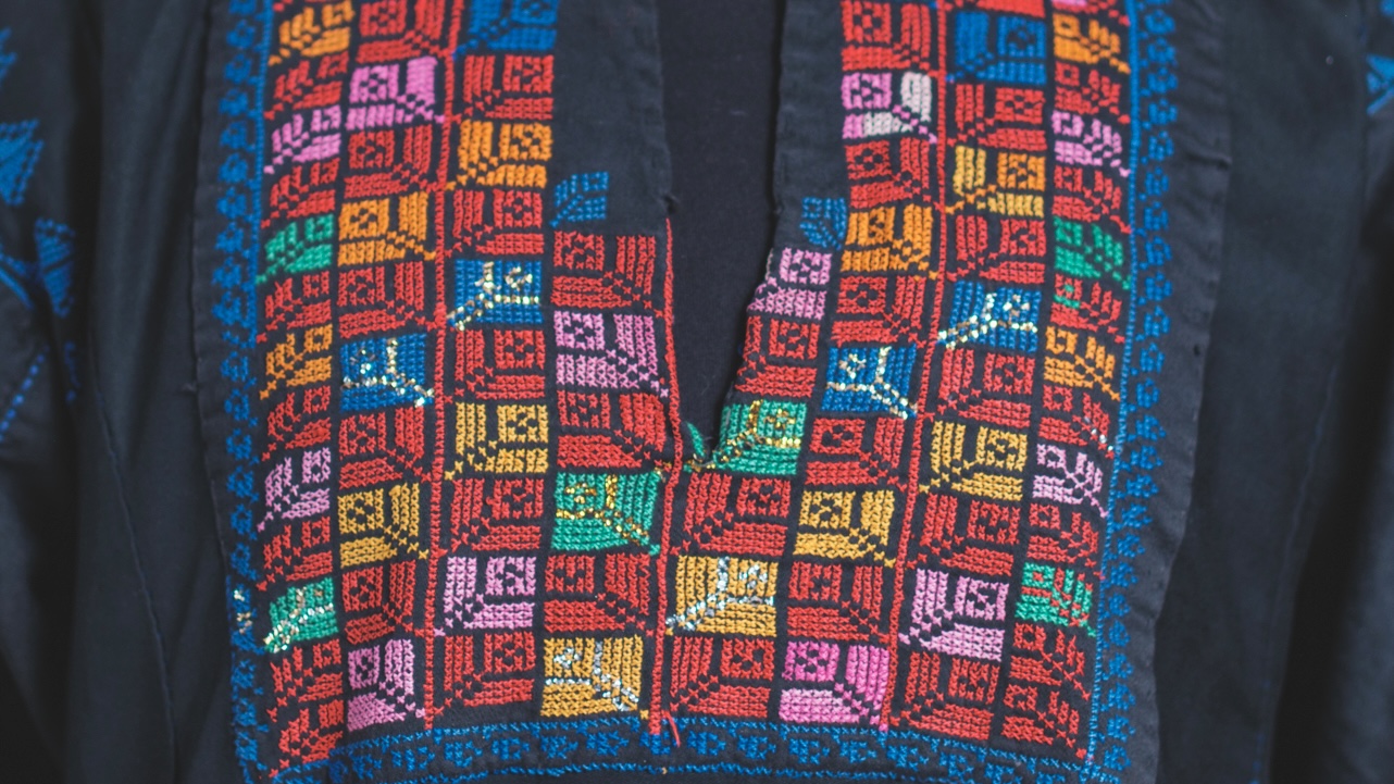 A close up image of a embroidered dress.