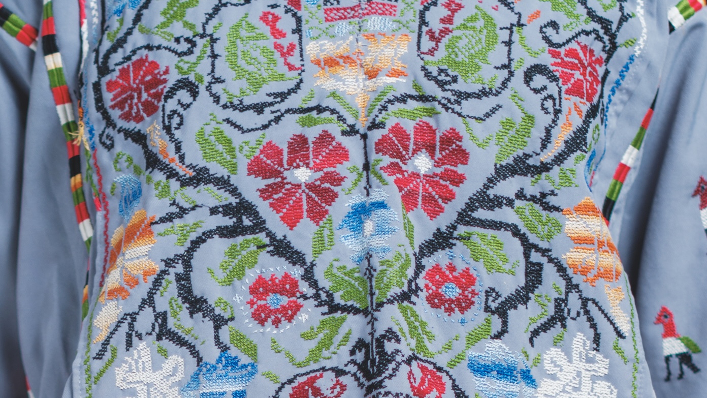 A close up image of a embroidered dress.