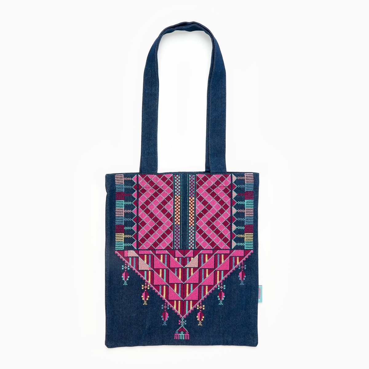 A tote bag with a blue and magenta design.