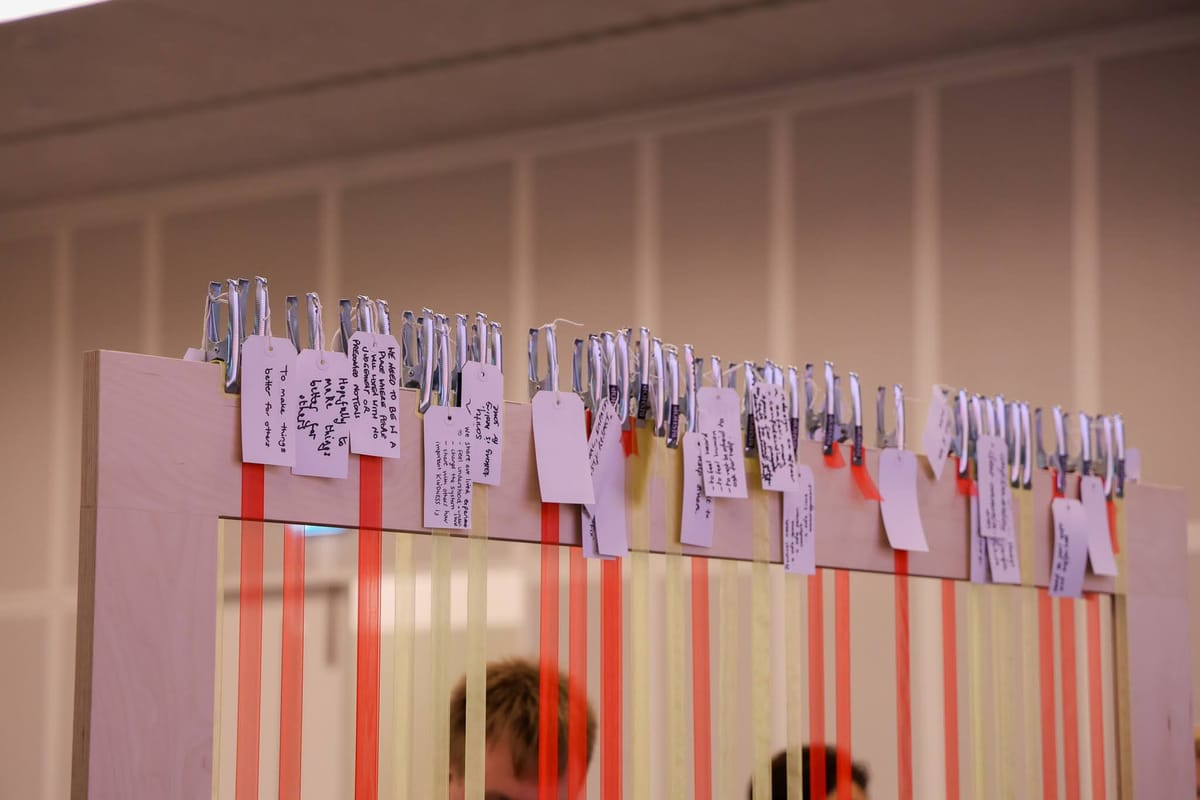 A wooden structure with tags attached with personal notes.