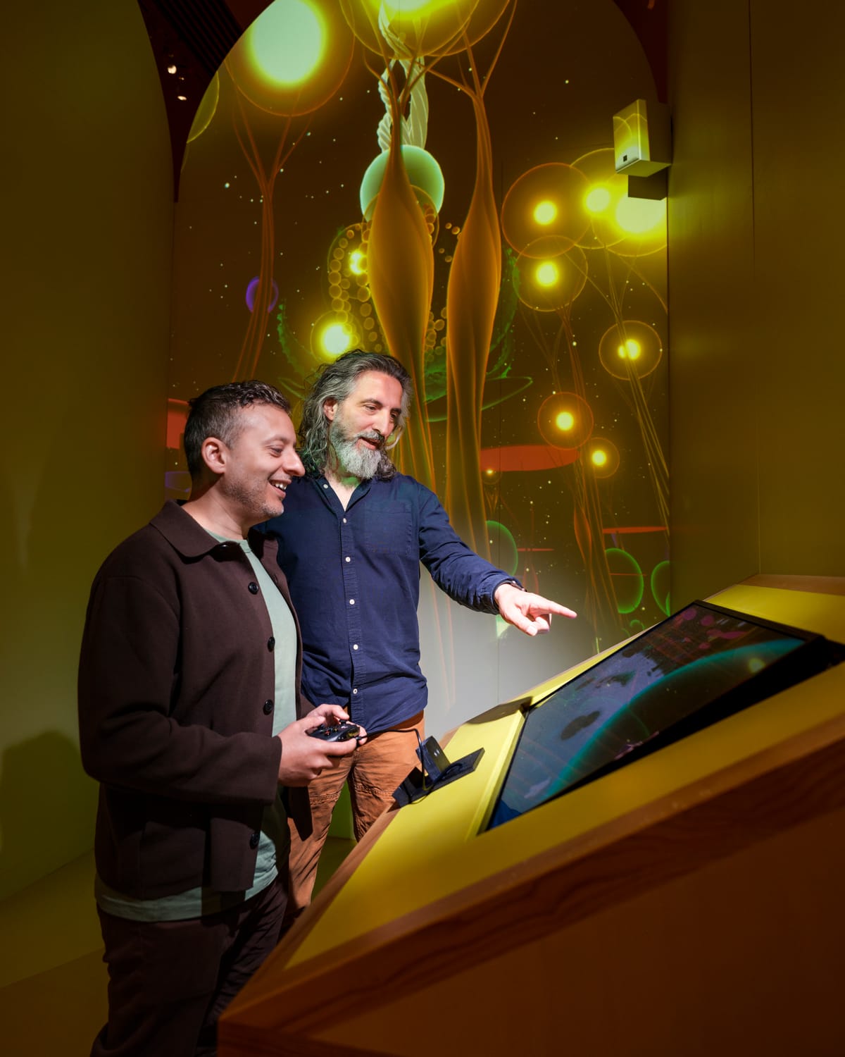 Two people standing playing a video game