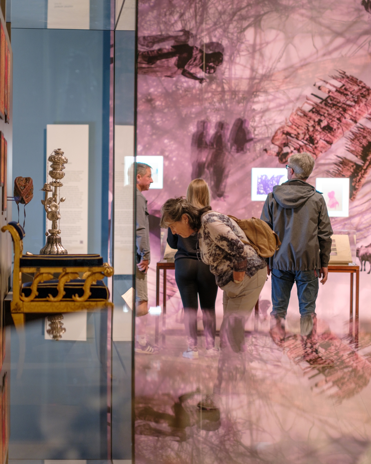 People looking at objects in a gallery.