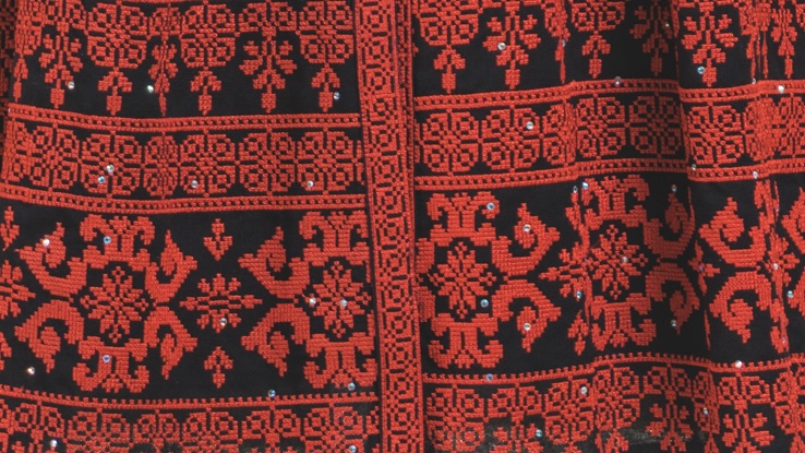 A close up of an embroidered dress.